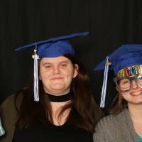 two people using props at GradFest photo booth
